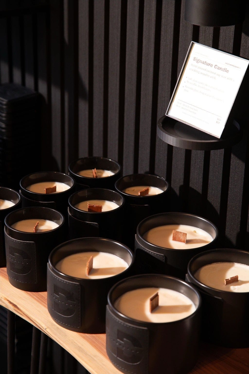 LeatherDaddy Signature Candles on the store shelf.