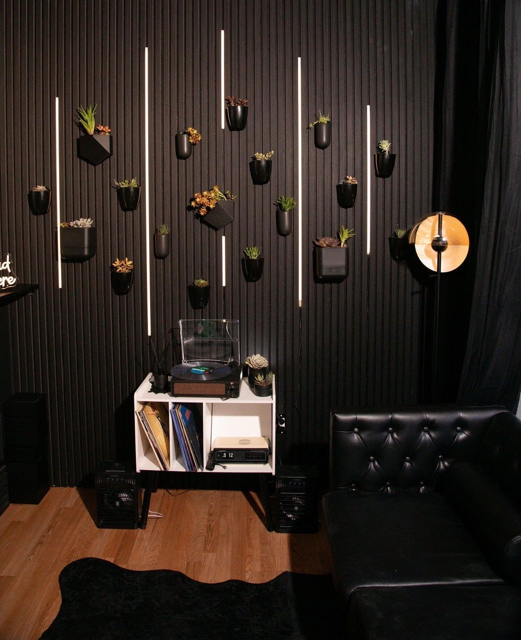 The succulent wall and seating area inside the LeatherDaddy store.